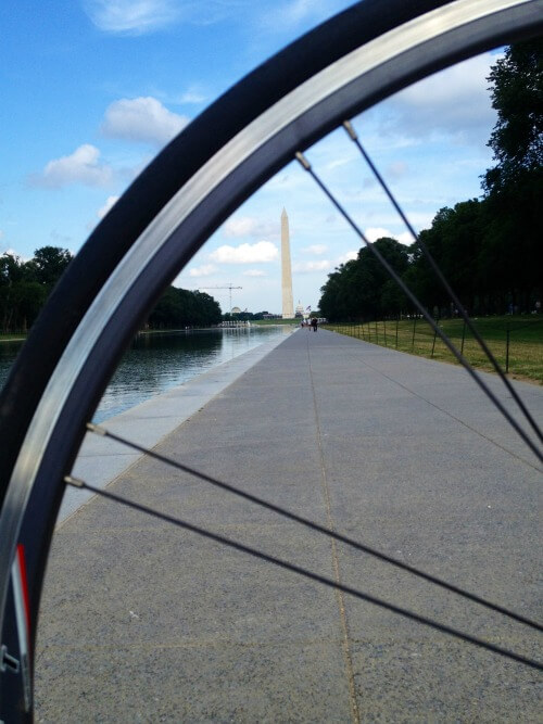 Investing in Expensive Market - Guy on Fire - view of the Washington Monument while riding bike