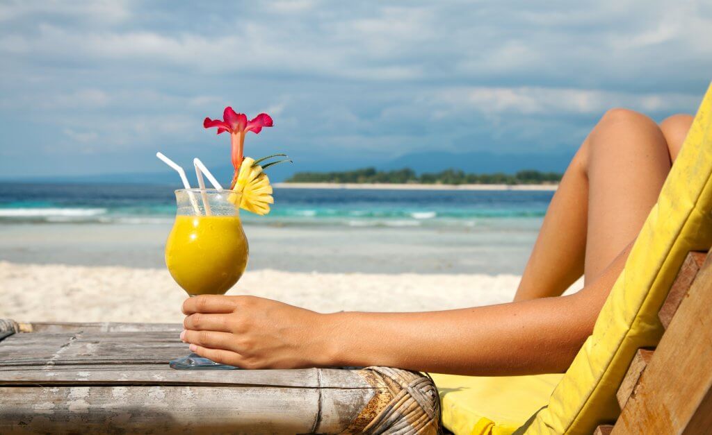 Pina colada on beach - What Suze Orman Got Wrong About the FIRE Movement