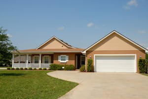 Beautiful modern suburban house with a spacious driveway and green lawn, perfect for families.